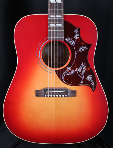Acoustic guitar with a sunburst finish on a black background
